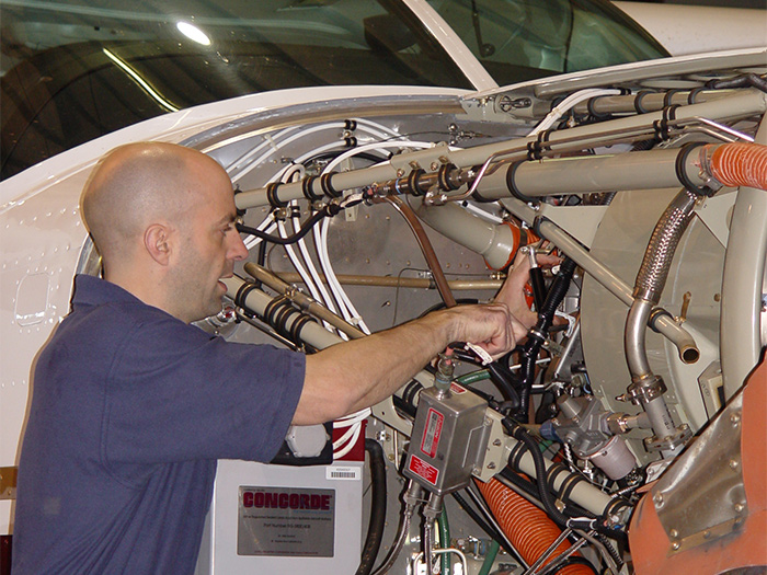 Wipaire maintenance tech working on a Cessna Caravan PT6 engine