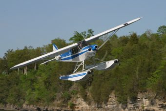 Piper Cub on Wipline 2100 Floats in Flight